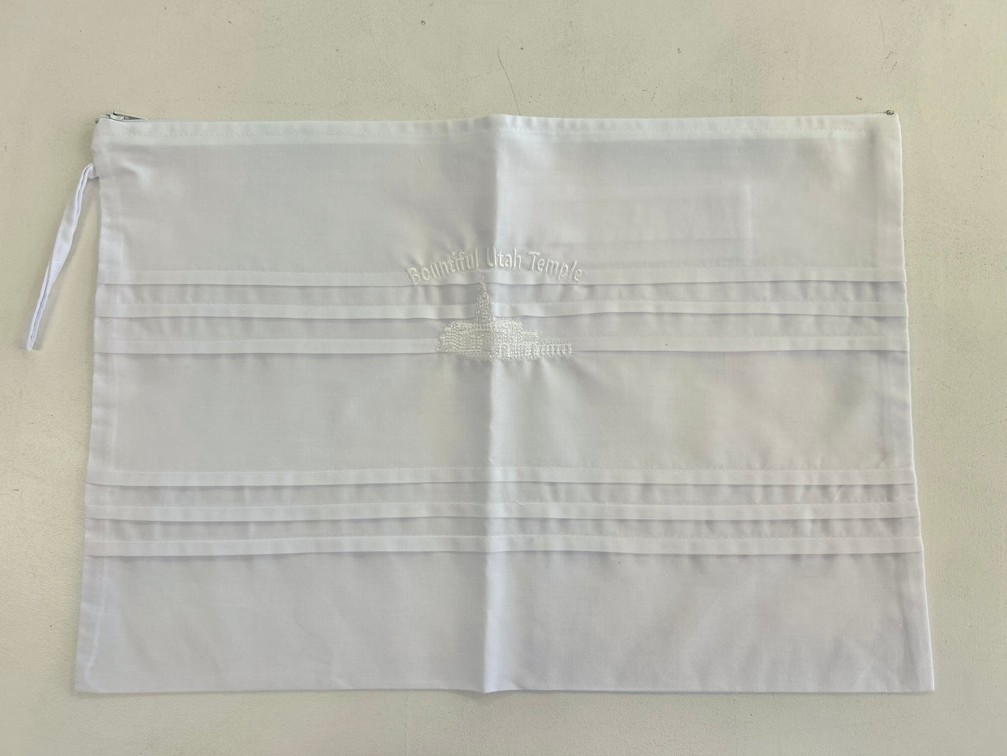 White cotton envelope with embroidery.