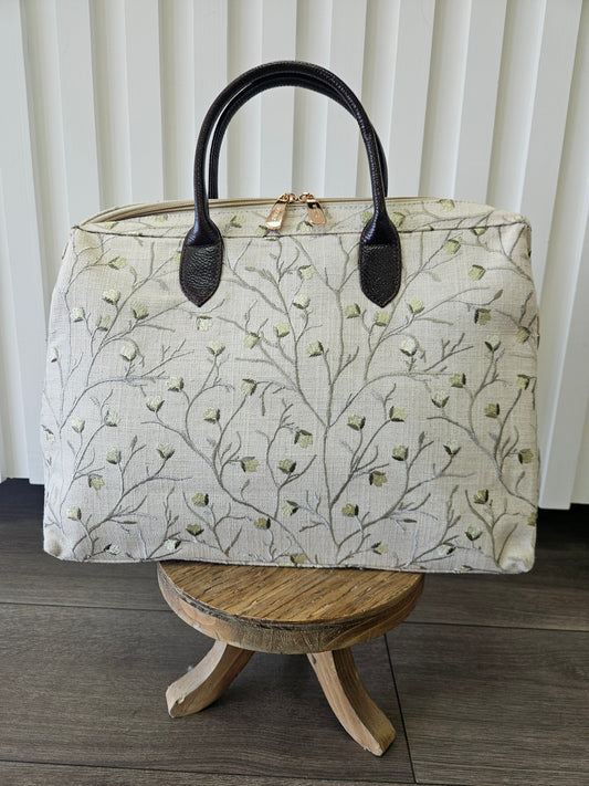 Beige zipper top purse with sage blossom design.