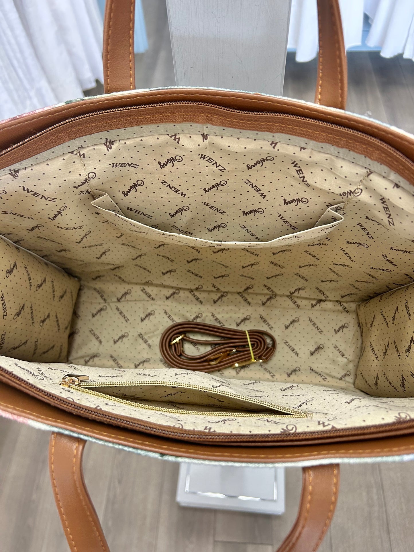 Inside tote with pockets and extra shoulder strap.