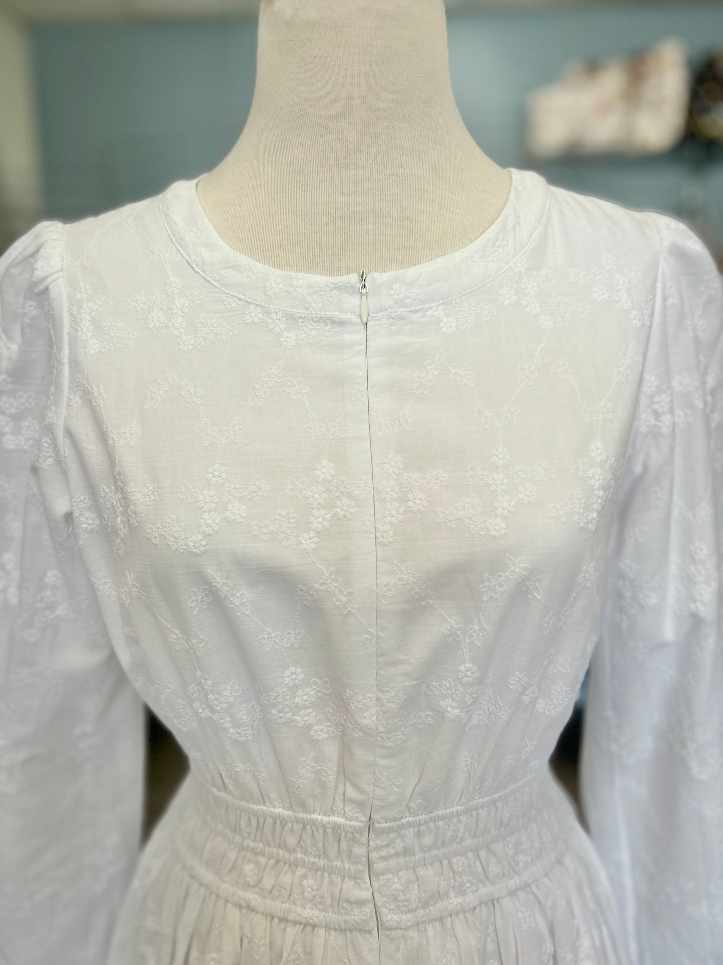 White zip front dress with embroiderey design.