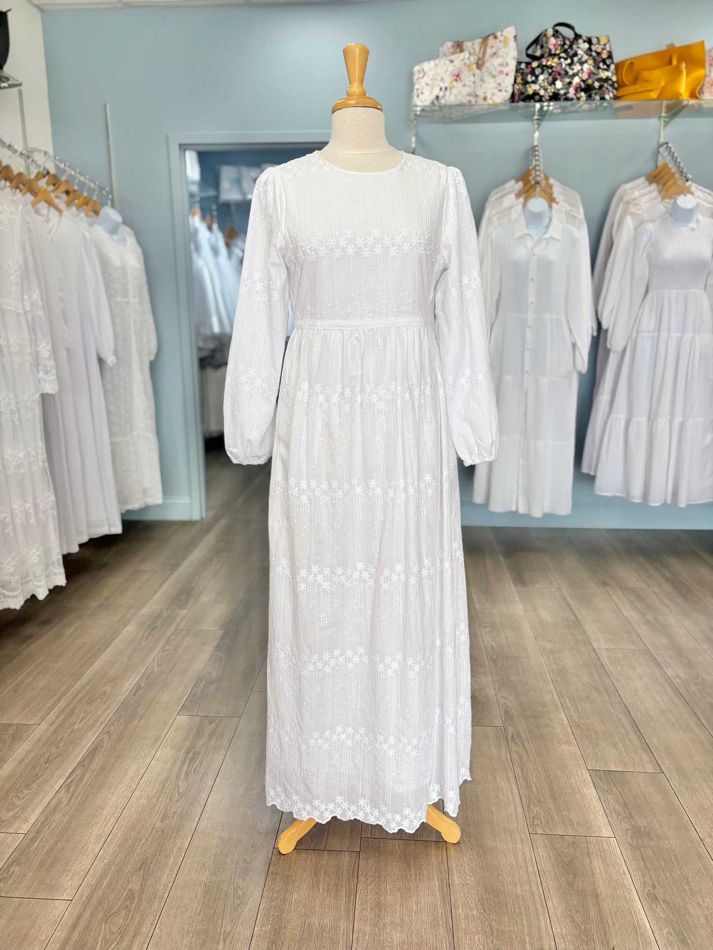 Long white cotton dress on mannequin. 