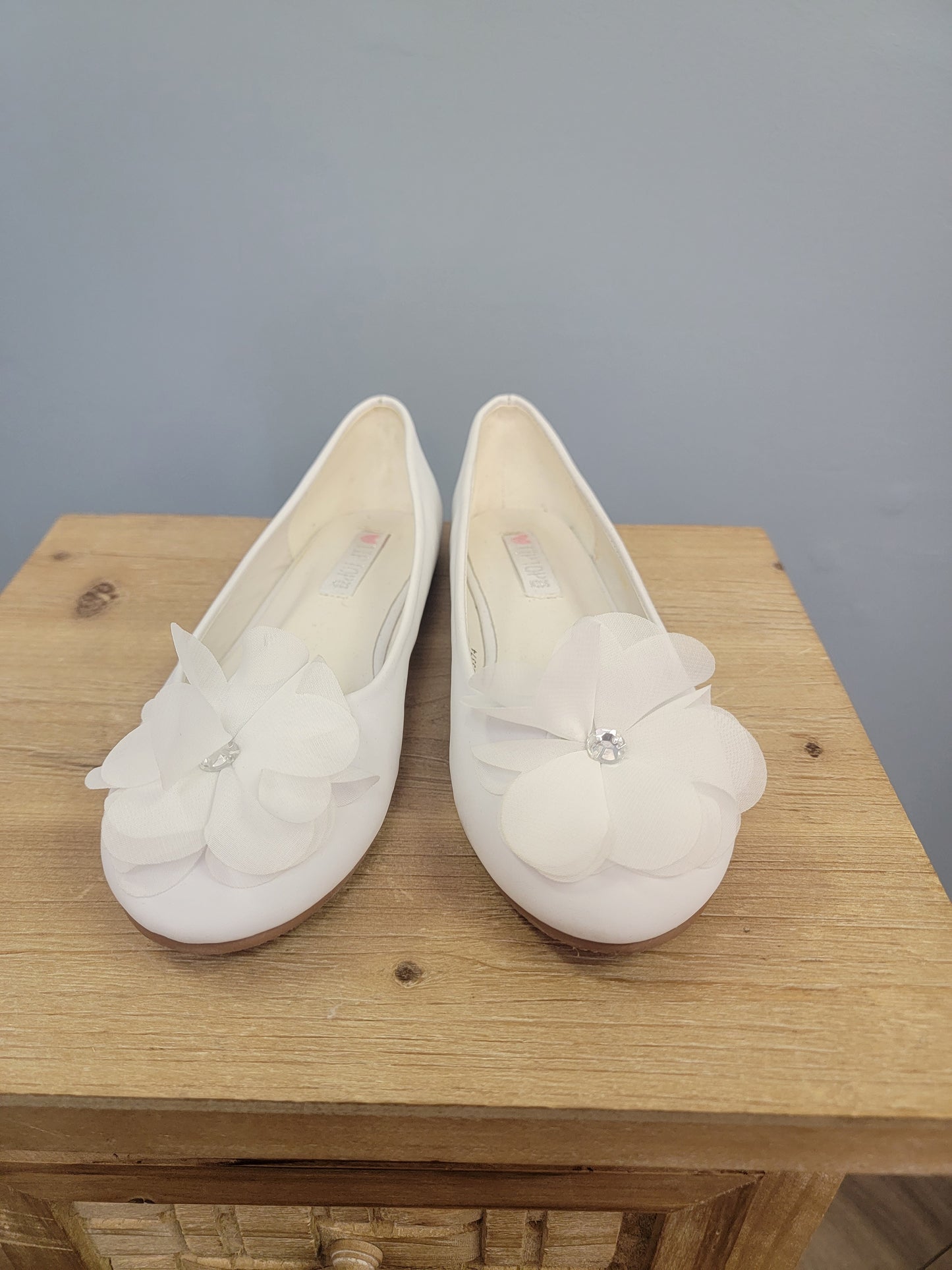 white girl's flats with flower on toe