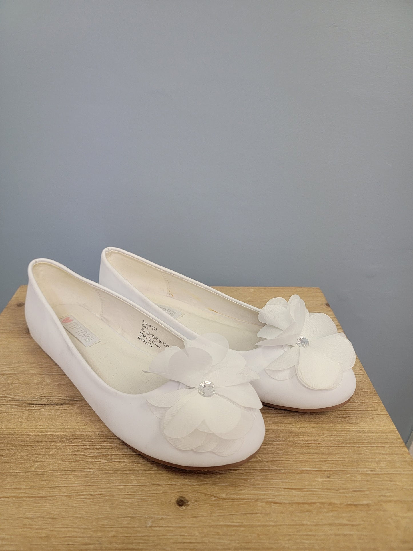 white girl's flats with flower on toe