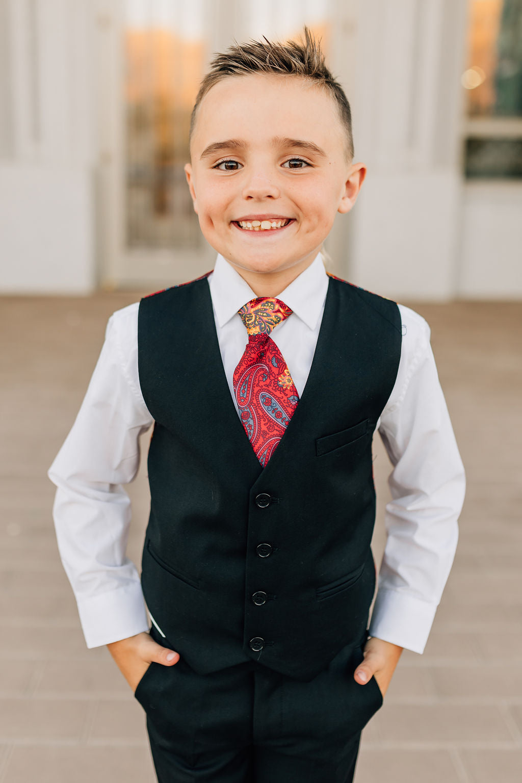 boy in black pants and vest