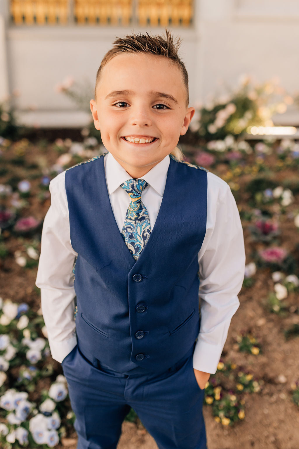 boy in blue dress pants and vest