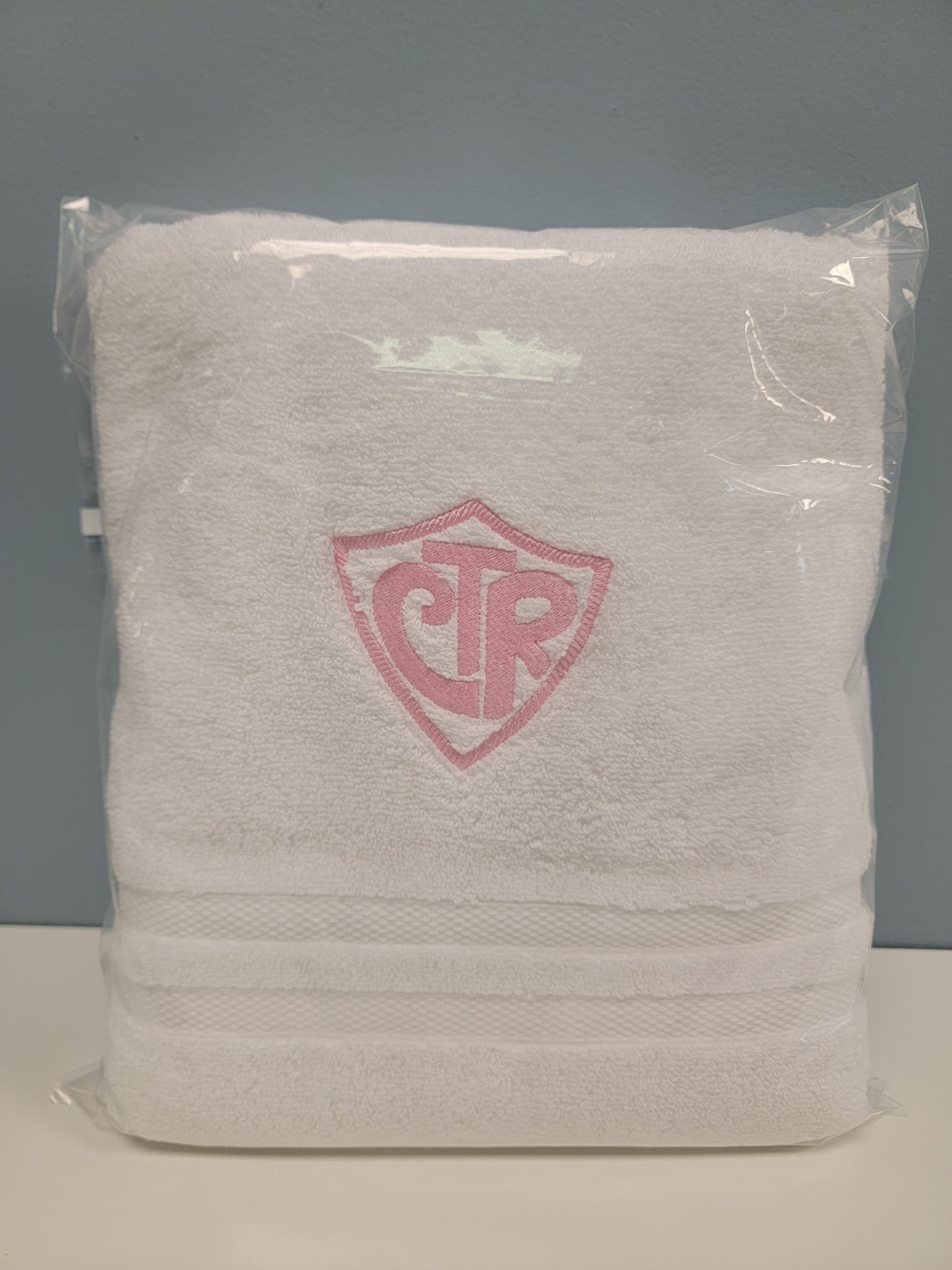 White baptism towel with embroidered CTR symbol